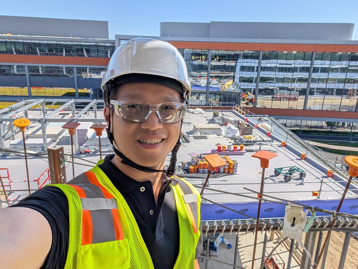 Xiao Liu in a hard hat and safety vest at a construction site